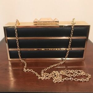 BCBGMaxazria black leather and gold clutch
